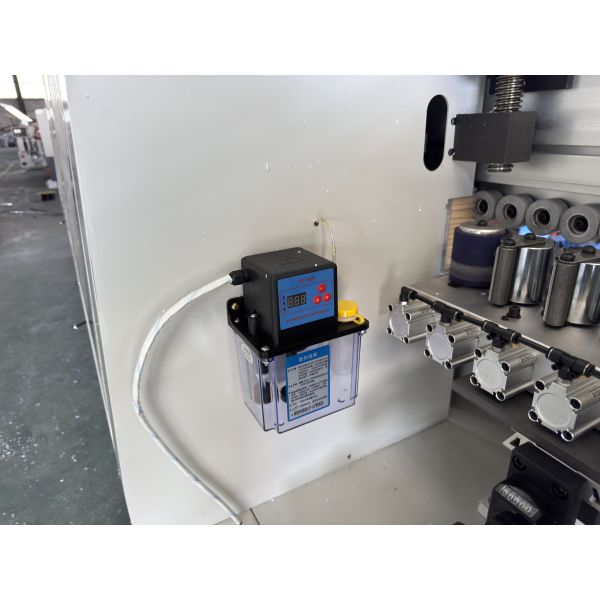 Close-up of edge banding machine's milling and application mechanism