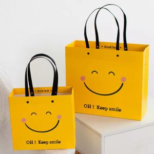 Buy cheap ISO Shock Resistant Smile Face Kraft Paper Bags Yellow Square Bottom Paper Bag product