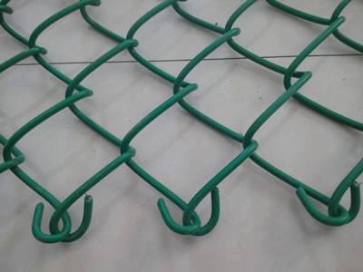 A part of chain link fence with twist ends is placed on the floor.